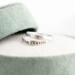 Sterling silver "I Am Charlie" tribute ring with cross, honoring Charlie Kirk, in a green velvet ring box with white flowers.
